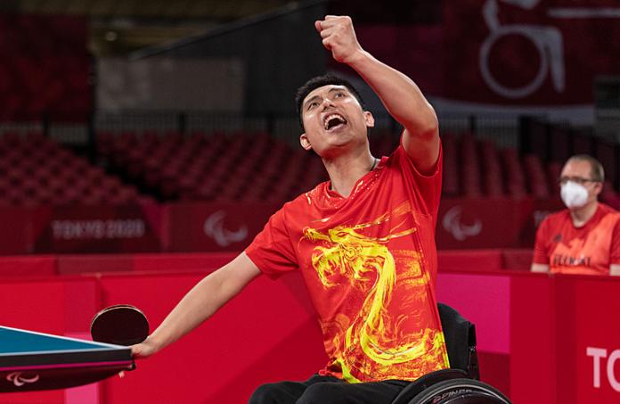 Chinese man in wheelchair celebrates after table tennis match