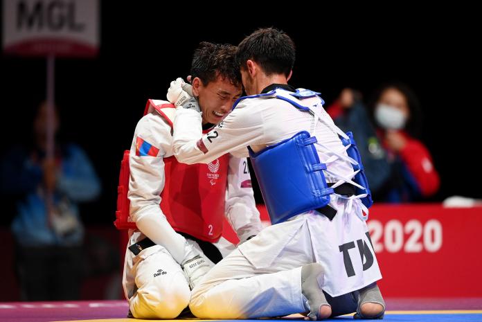 Turkey's Mahmut Bozteke consoles Mongolia's Bolor Erdene Ganbat after victory in the bronze medal-combat