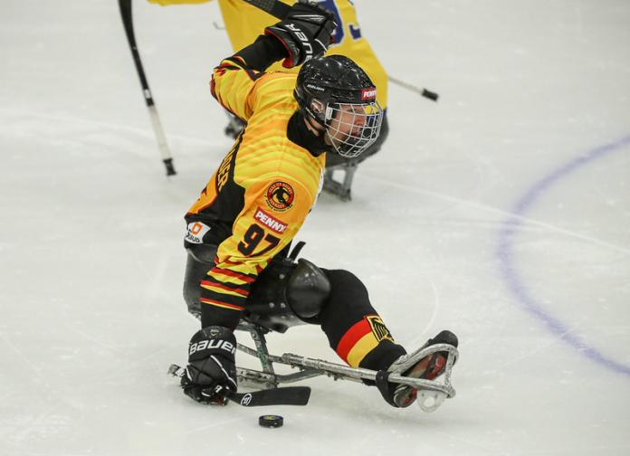 A Para ice hockey player with the Germany uniform on an ice rink