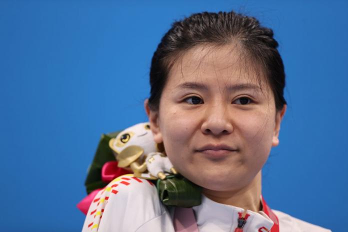 Gold medalist Dong Lu of China poses during the medal ceremony for the Women's 200m Individual Medley - SM5 final at Tokyo 2020 Paralympic Games. 