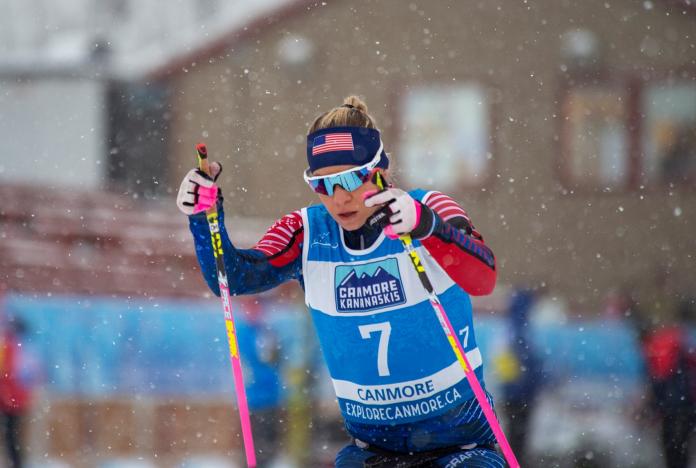 A woman competing in a Para cross-country race under snow