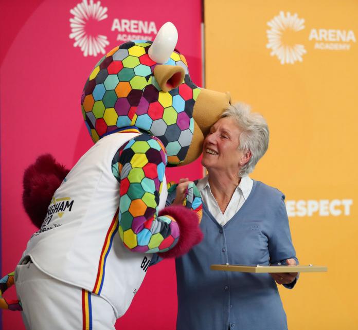 Perry, Birmingham 2022's official mascot pictured with CGF President Dame Louise Martin, at Arena Academy in Birmingham, England. 