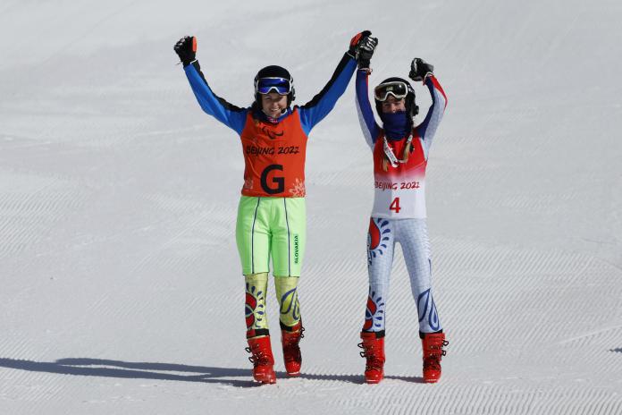 Alexandra Rexova celebrates with guide Eva Trajcikova during the flower ceremony 