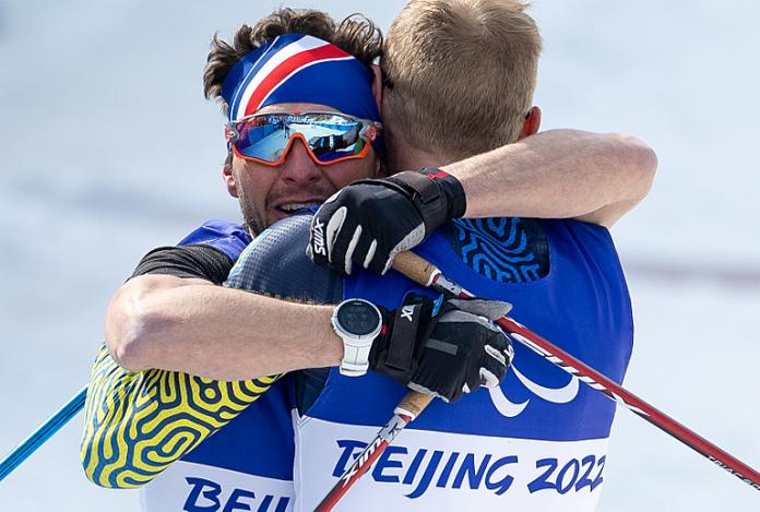 Benjamin Daviet of France embraces Grygorii Vovchynskyi of Ukraine on the finish line of the men's sprintoi