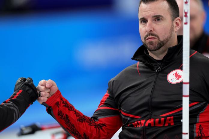 Two Canadian wheelchair curler bump fists