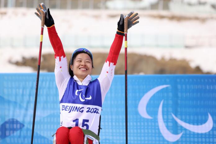 Gold medallist Hongqiong Yang of China celebrates her win in the Women's Sprint Sitting at the Beijing 2022 Paralympic Winter Games at Zhangjiakou National Biathlon Centre.