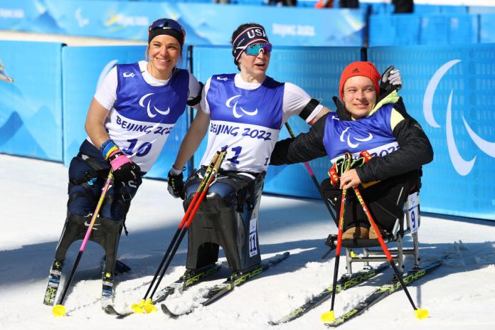 CHAMPIONS ALL: (L) Silver medalist Oksana Masters of United States, Gold medalist Kendall Gretsch United States and Bronze medalist Anja Wickers of Team Germany pose during Para Biathlon Women's Middle Distance Sitting flower ceremony. 