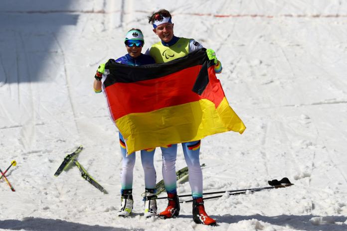  Linn Kazmaier of Germany celebrates with her guide Florian Baumann after winning the gold medal in the Women's Middle Distance Free Technique Vision Impaired at the Beijing 2022 Winter Paralympics at Zhangjiakou National Biathlon Centre.