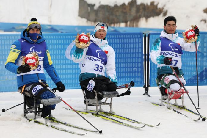 CLASS ACT: Gold medallist Mengtao Liu (C) of China, silver medallist Taras Rad (L) of Ukraine, bronze medallist Zixu Liu of China pose during the Para Biathlon Men's Individual Sitting medal ceremony. 