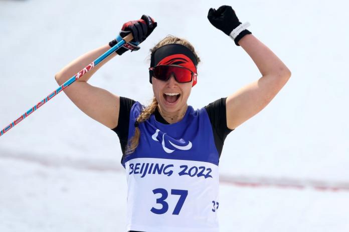 Canada's Natalie Wilkie celebrates her gold in the Women's Sprint Free Technique Standing in the Beijing 2022 Paralympic Winter Games at Zhangjiakou National Biathlon Centre.