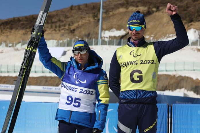 IN THE FORM OF HER LIFE: Gold medallist Oksana Shyshkova of Ukraine (left) with guide Andriy Marchenko celebrates after winning  the Para Cross-Country Skiing Women's Long Distance Classical Technique Vision Impaired at the Beijing 2022 Winter Paralympics.