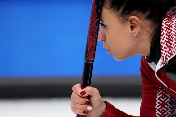 A close-up of the face of Latvia's Polina Rozhkova as she holds her curling stick