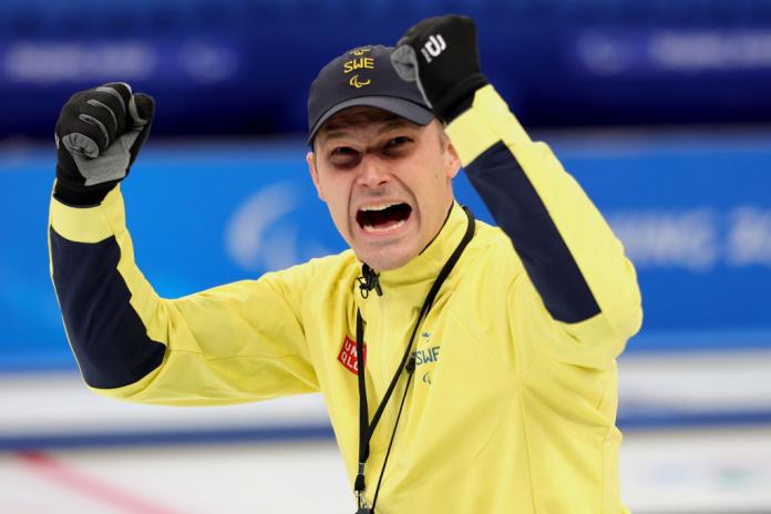 Viljo Pettersson-Dahl of Team Sweden celebrates defeating Team Slovakia during the wheelchair curling semi-finals of Beijing 2022