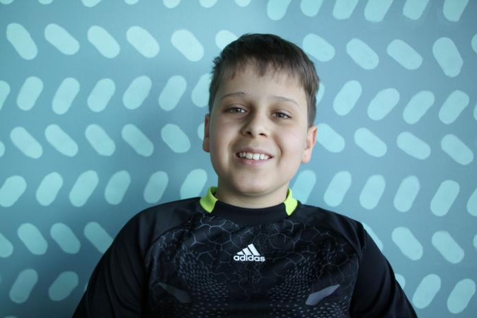 Adrian Ruf smiles in a portrait photo while wearing his sports gear.