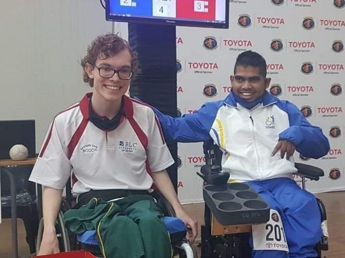 Liakath Aziz pats a fellow South African competitor on the back after winning his boccia match.
