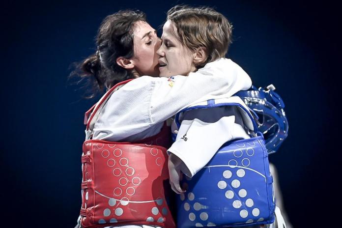 Ukraine's Vika Marchuk embraces her opponent at the 2022 European Championships in Manchester.