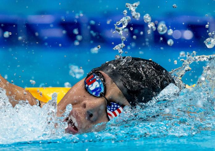 Anastasia Pagonis breathes during her women's 400m freestyle S11 final at Tokyo 2020, her goggles marked with the USA flag and name.
