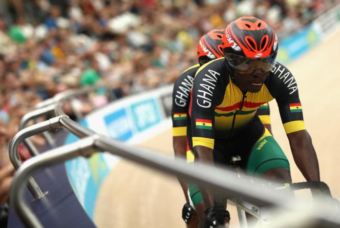 Ghana's Frederick Assor and pilot Rudolf Mensahcompete race on the track in a crowded velodrome at the 2018 Commonwealth Games.