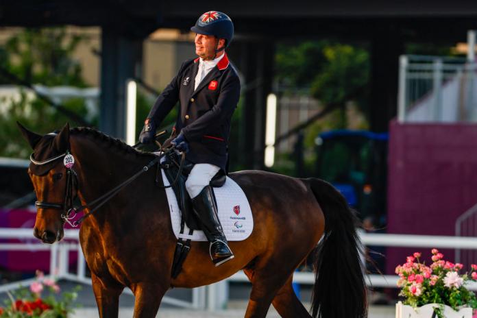 Lee Pearson smiles as he rides his horse Breezer in the dressage individual test grade II competition at Tokyo 2020.