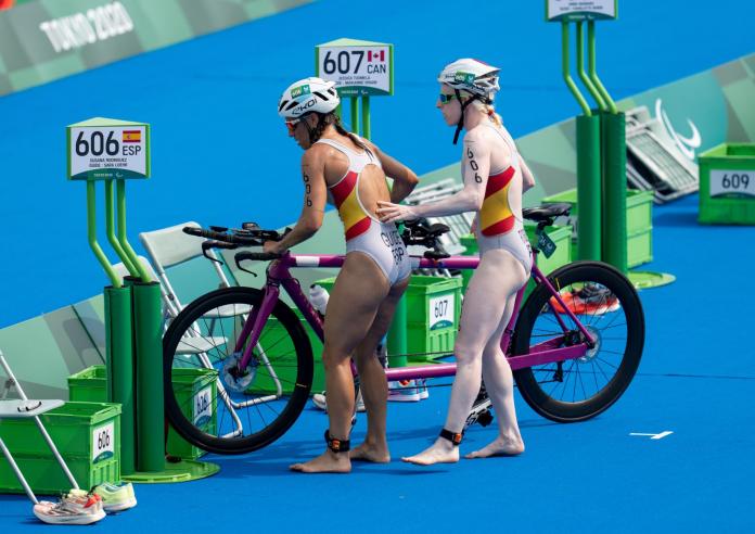Susana Rodriguez and her guide Sara Loehr park their tandem in the transition area at the Tokyo 2020 Paralympic Games.