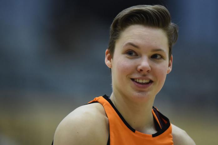 A close up of Bo Kramer smiling at the camera in her uniform during a wheelchair basketball match.