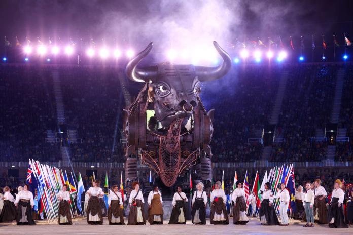 A giant sculpture of the city’s symbol, a bull, stands in the stadium during the Opening Ceremony with performers lining up in front of it.