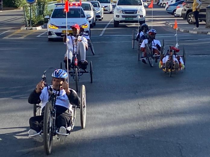 Handcyclists ride through the centre of the Namibian capital Windhoek.