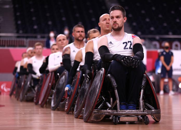Players of Great Britain's wheelchair rugby team form a line before their gold medal match at Tokyo 2020 Paralympic Games.