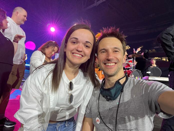 A female athlete poses for a selfie with a music video director.