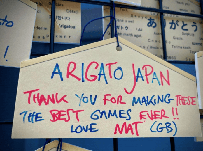 A traditional Japanese plaque with a message by Whitecross written in red and blue.
