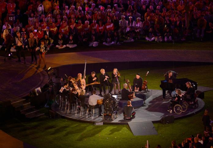 Musicians in wheelchairs and on chairs perform in a circle during the Closing Ceremony of the London 2012 Games.