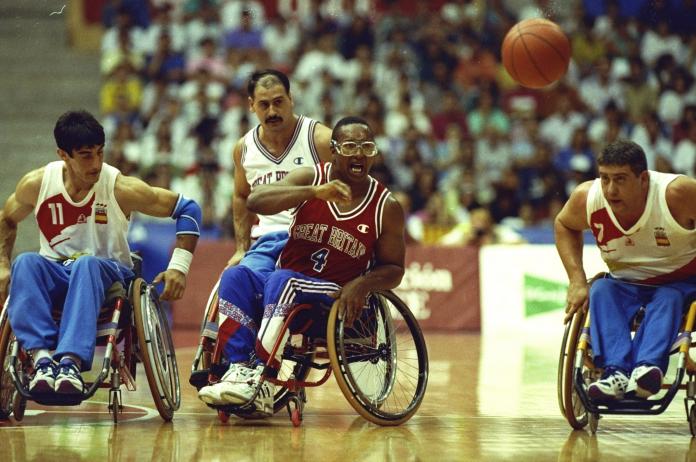 Athletes from Great Britain and Spain compete in wheelchair basketball.