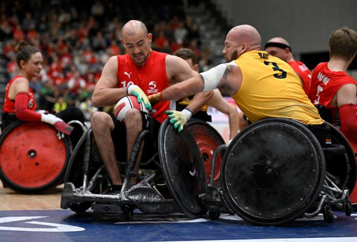Two wheelchair rugby players play in a match