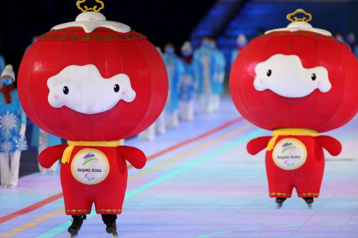 Two red mascots of the Beijing 2022 Games roller skate in the stadium during the Opening Ceremony.
