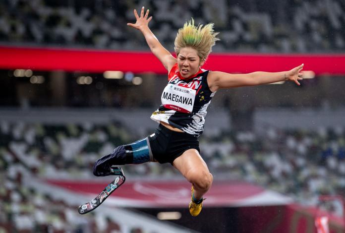 A female athlete wearing a blade jumps during competition at Tokyo 2020