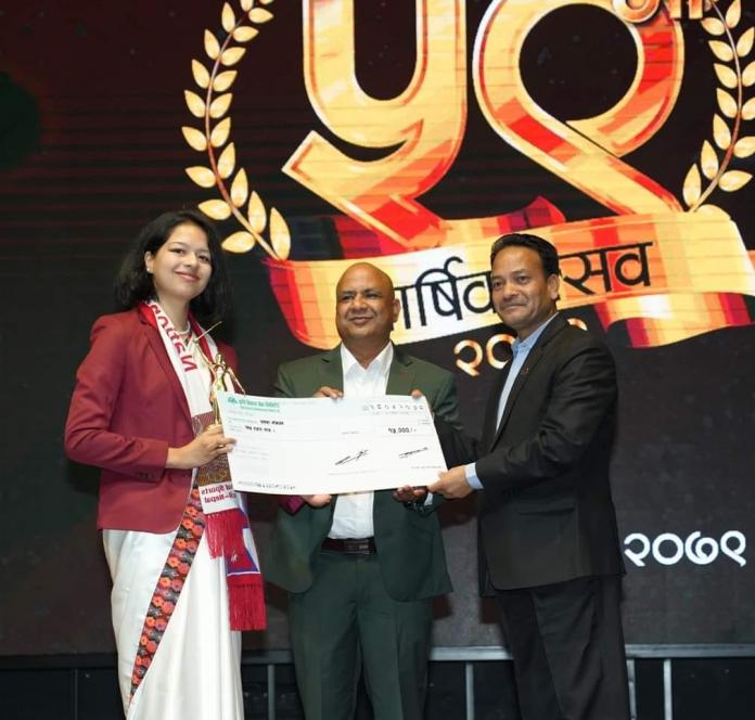 A female and two males in suits hold up a certificate while on stage at a formal ceremony.