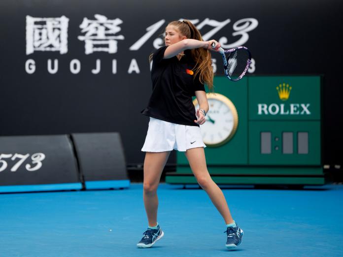 A female tennis player swings the racket.