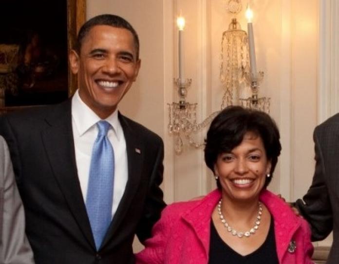 A woman posing for a photograph with US President Barack Obama