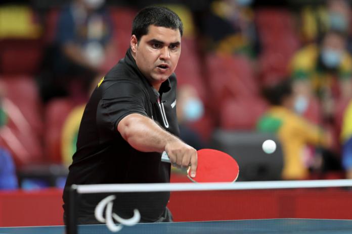A male athlete competes in Para table tennis at Tokyo 2020.