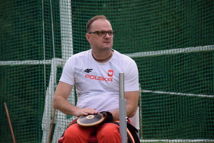 A male athlete prepares to throw a discus.