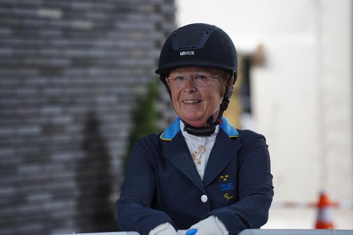 A close-up of a female athlete wearing an equestrian gear