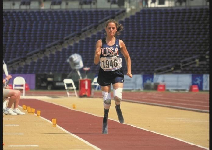 A female athlete with running blades compete at the Atlanta 1996 Paralympic Games