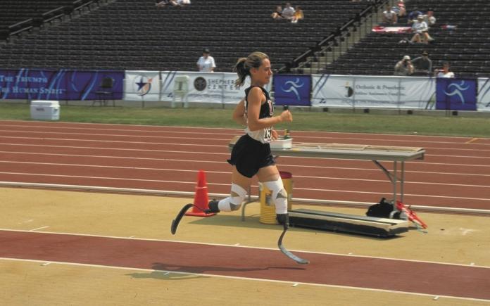 A female athlete with running blades compete at the Atlanta 1996 Games.