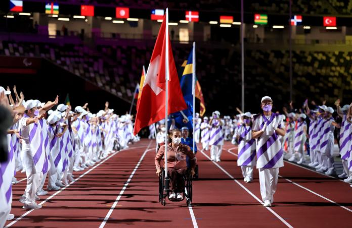 Wheelchair athlete Catherine Debrunner carries the Swiss flag at Tokyo 2020