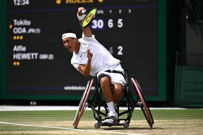 A male wheelchair tennis player competes