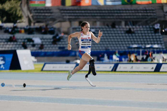 A female athlete wearing a blade runs