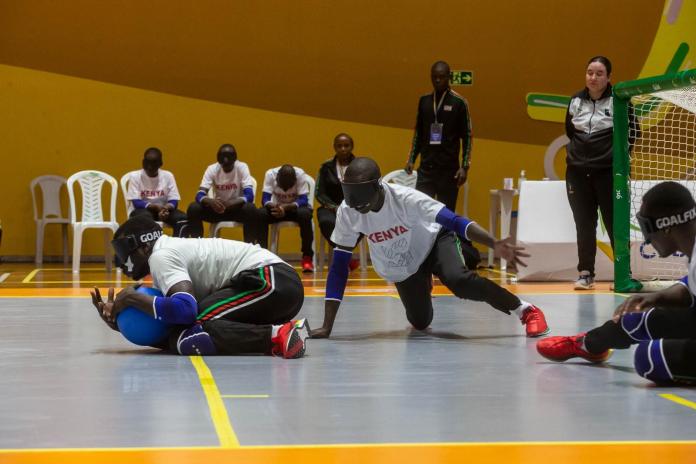 three young Kenyan Goalball players fight for the ball 