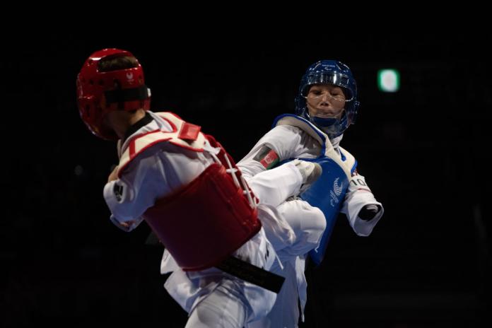 Two female Para taekwondo athletes fighting