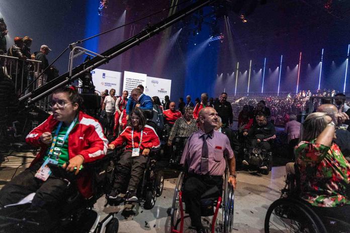 wheelchair athletes joining an Opening Ceremony parade 