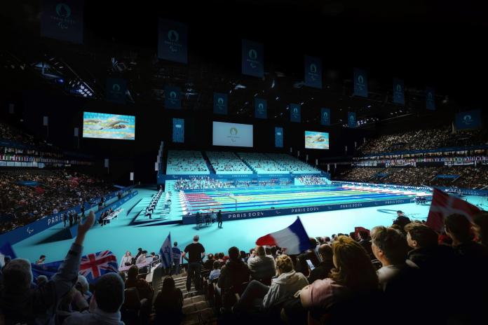 a wide shot of a swimming pool surrounded by spectators